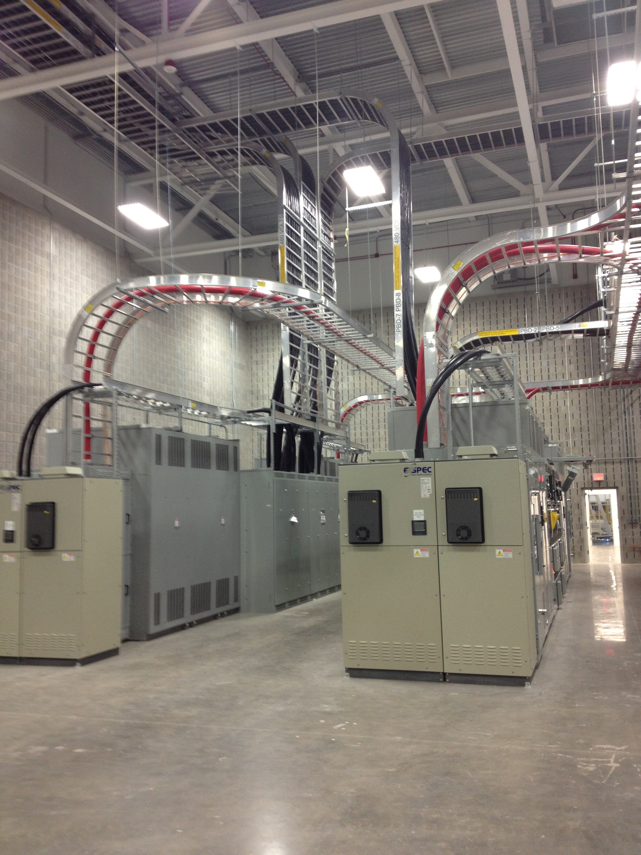 A picture of an intricate cable tray system designed by the Aeries CARS software with cables landing into an electrical equipment